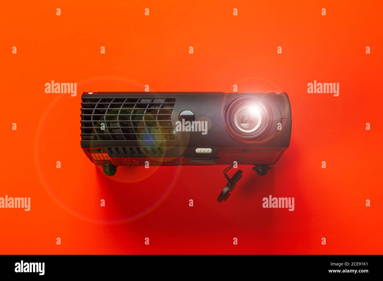 glowing cinema projector on red background Stock Photo