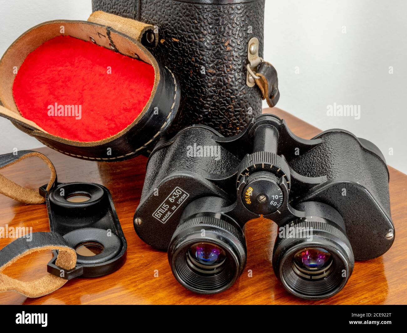 Vintage Russian binoculars, metal construction, etched with БПЦ5 8x30 MADE  IN USSR. Pair of light / sun eyepiece filters and leather case are nearby  Stock Photo - Alamy