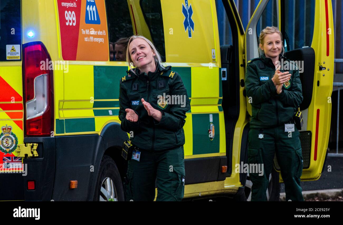 Two paramedics clapping outside Harrogate Hospital as they take part in Clap for our Carers. Stock Photo