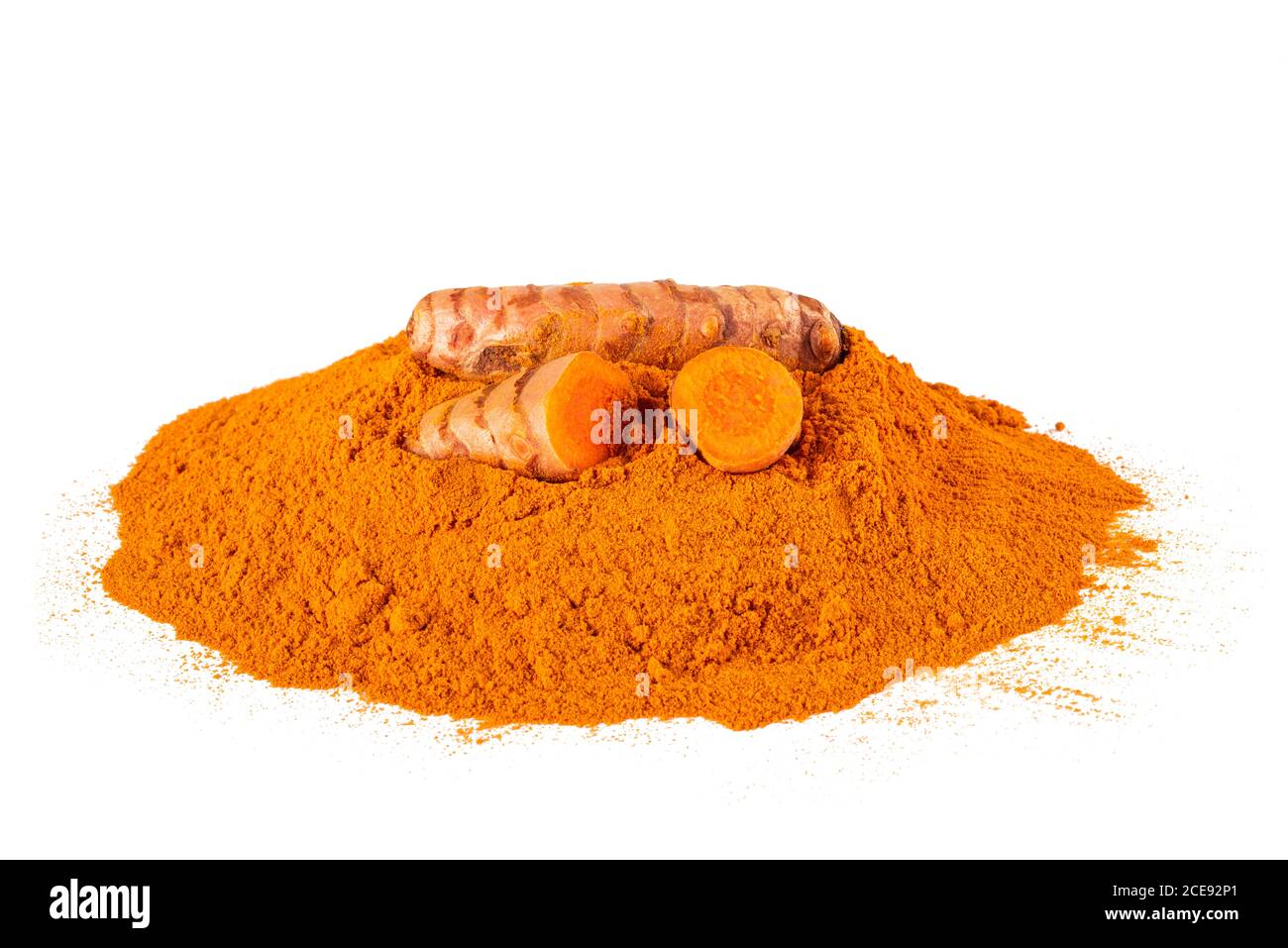 Curcuma powder with roots isolated on white Stock Photo