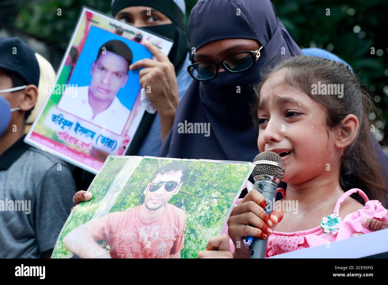 Dhaka, Bangladesh - August 29, 2020: Little Hridy speaks as tears roll down her cheeks. She was speaking at a programmed organized by Mother’s Call in Stock Photo