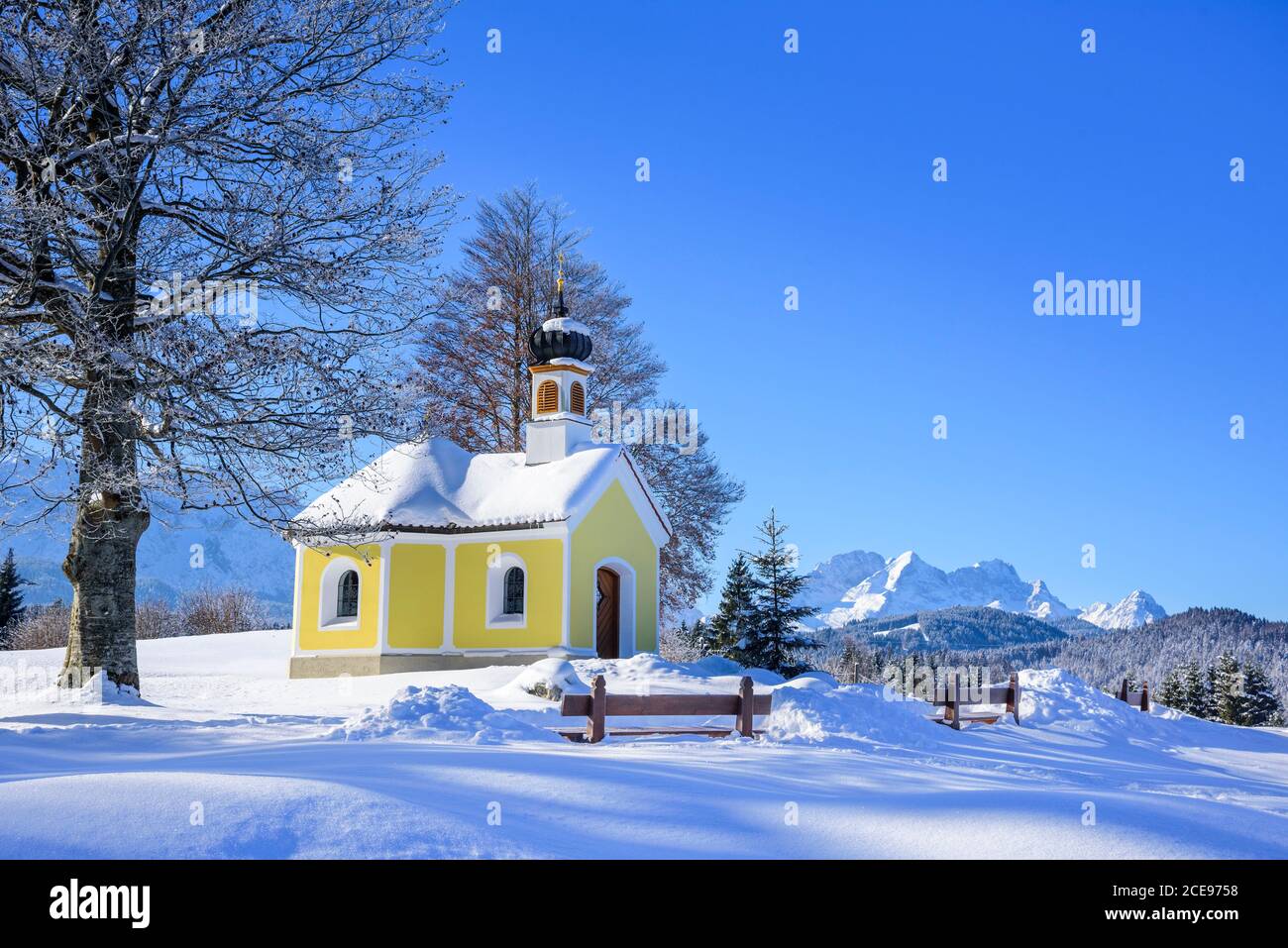 Little chapel in wintry landscape near Krün in bavarian alps Stock