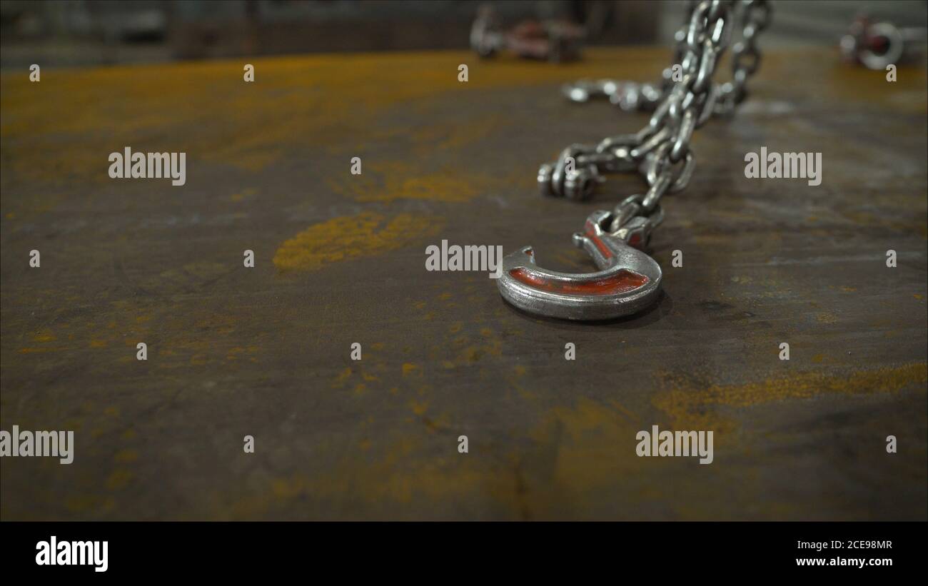 Low angle view of manual worker operating crane lifting sheet metal in