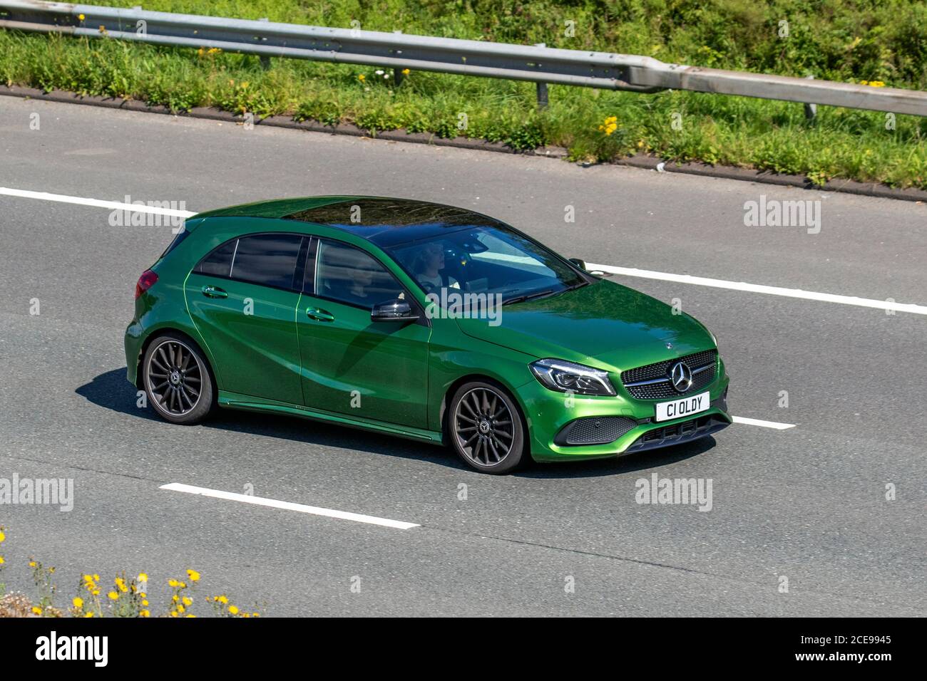 Green Mercedes-Benz A 200 D AMG Line Premium; Vehicular traffic moving vehicles, cars driving vehicle on UK roads, motors, motoring on the M6 motorway highway network. Stock Photo