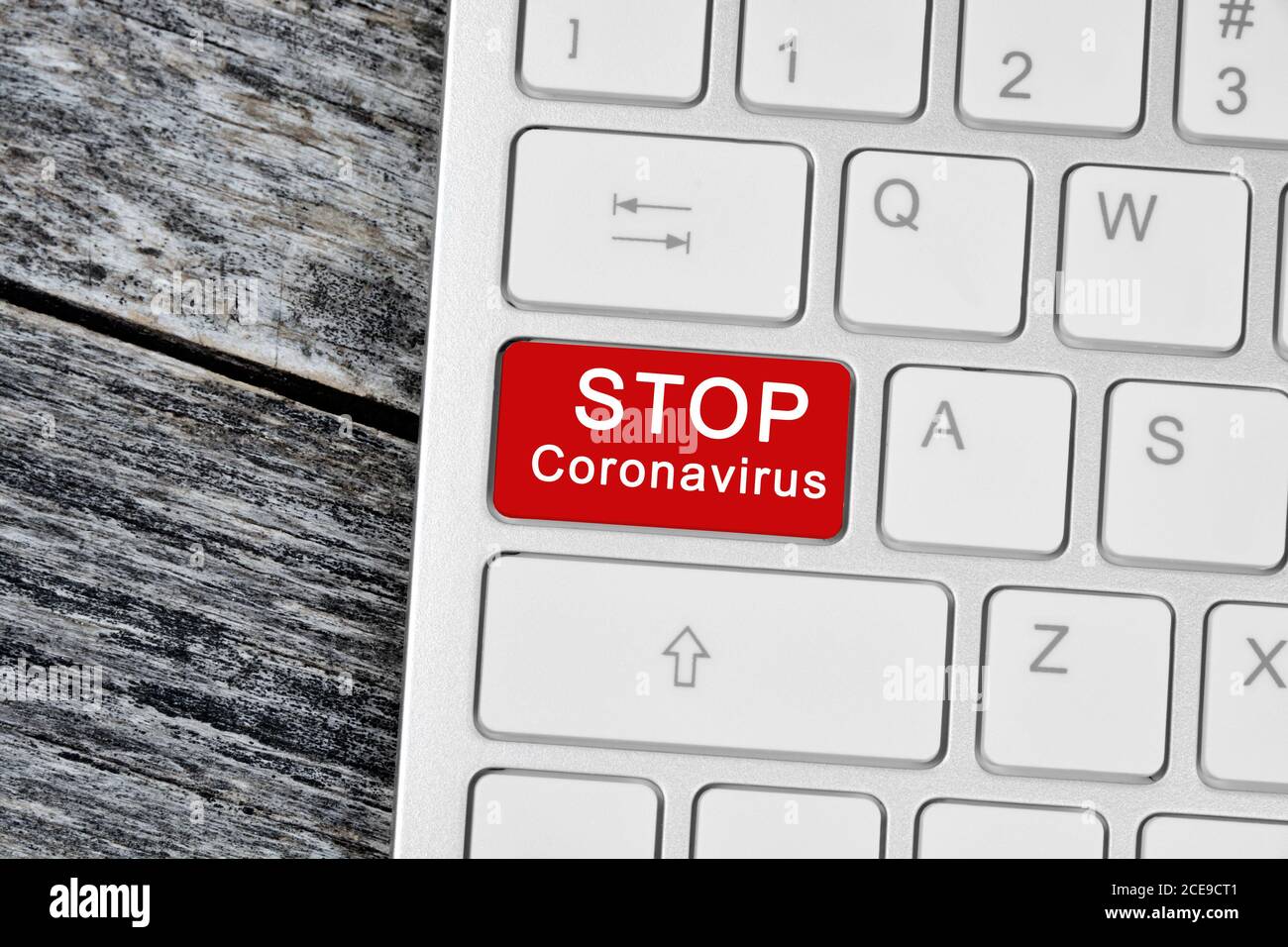 Stop coronavirus words on red button computer keyboard close-up Stock Photo