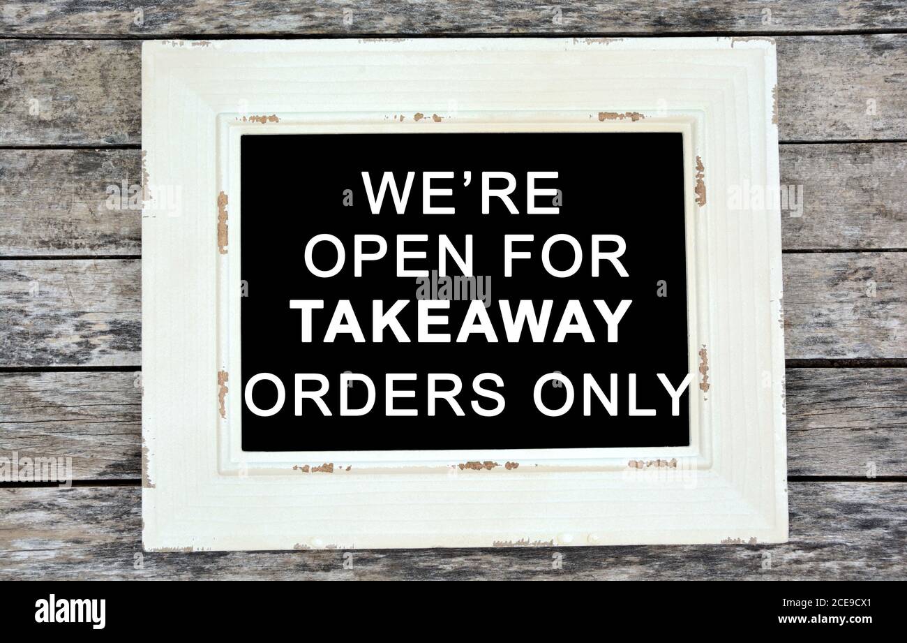 We're open for takeaway orders only text on small chalkboard Stock Photo