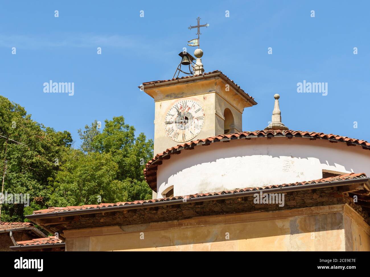 View of the Dome with old clock of the deconsecrated Church of S. Carlo in ancient village Castello Cabiaglio in the province of Varese, Lombardy, Ita Stock Photo