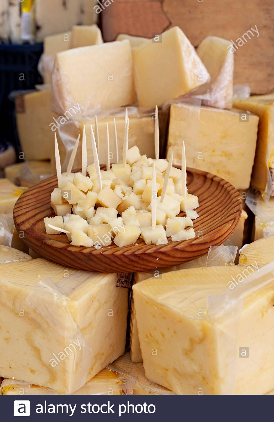Sale of cheese in a market and a plate to try the product for free. Food. Stock Photo