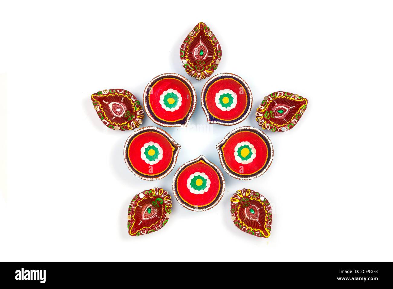 Happy Diwali - Clay Diya lamps lit during Dipavali, Hindu festival of lights celebration. Colorful traditional oil lamp diya on white background. Copy Stock Photo