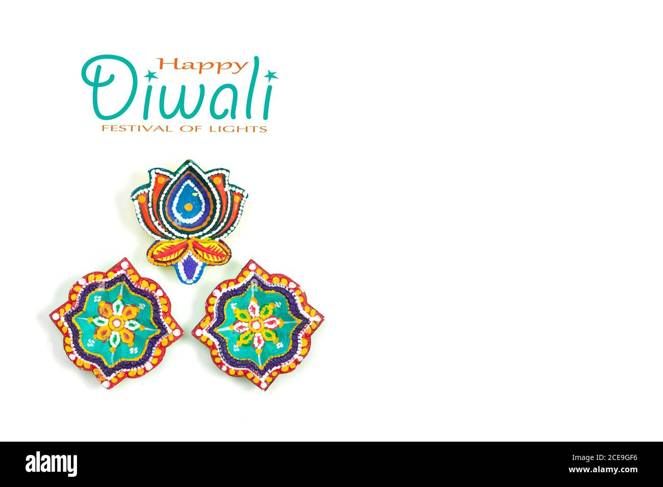 Happy Diwali - Clay Diya lamps lit during Dipavali, Hindu festival of  lights celebration. Colorful traditional oil lamp diya on white background.  Copy Stock Photo - Alamy