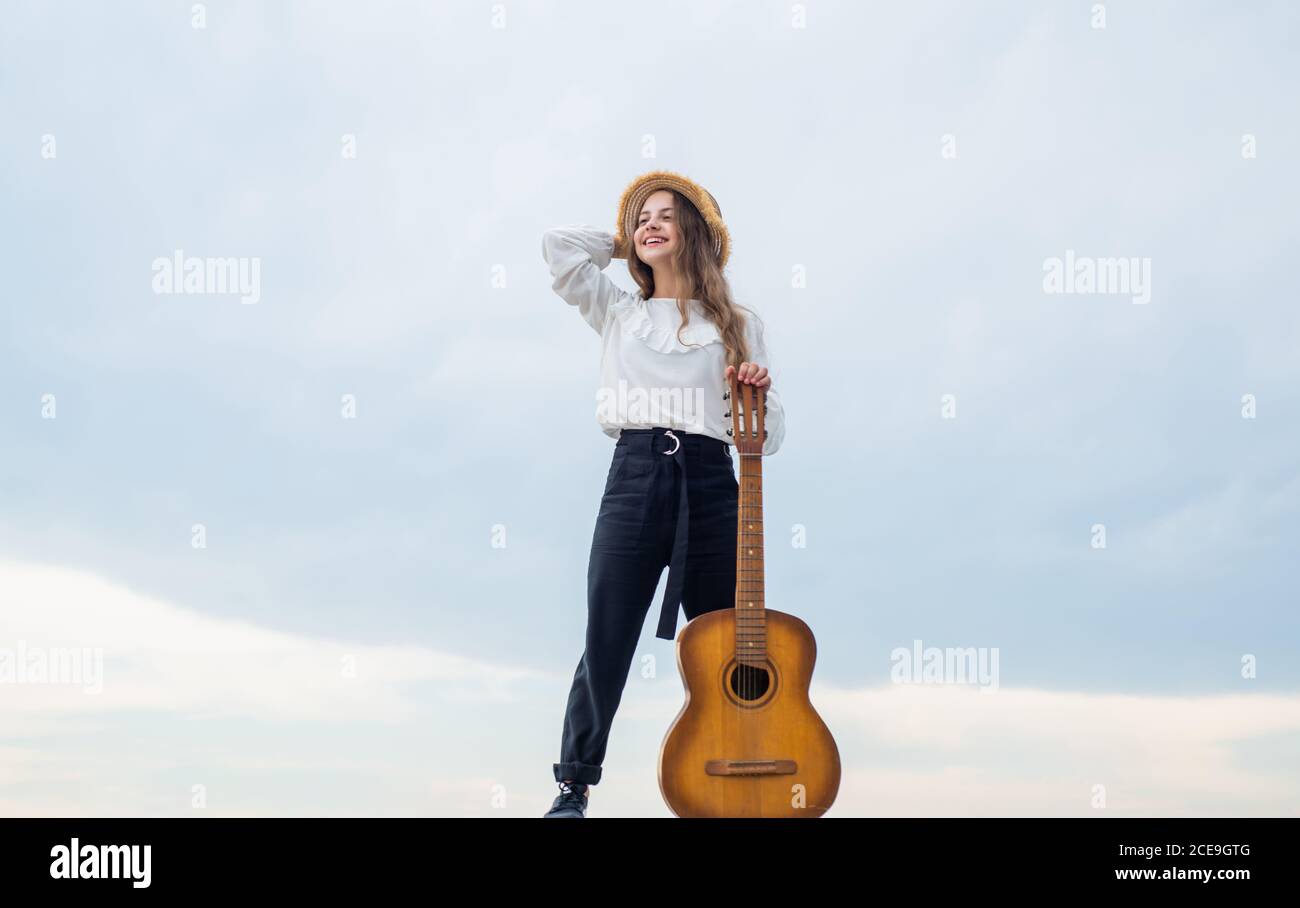 Lounge style performer. Lifestyle and People Concept. playing the guitar.  play on instrument. having a party. Happy kid with acoustic guitar. music  concept. Singing Songs. talented girl musician Stock Photo - Alamy
