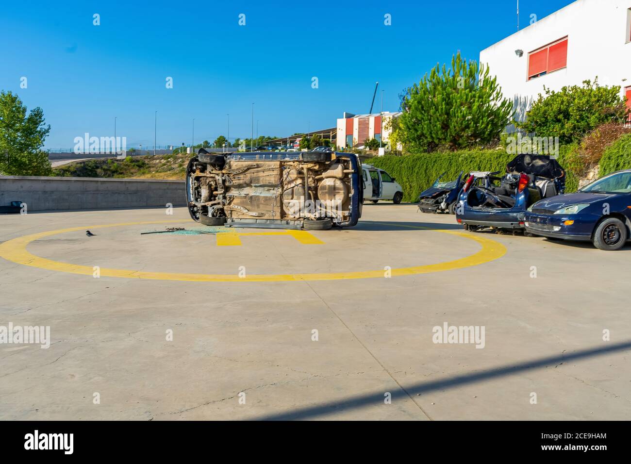 Wrecked and overturned cars used for future firefighter practice in the yard of the firehouse. Learning concept Stock Photo