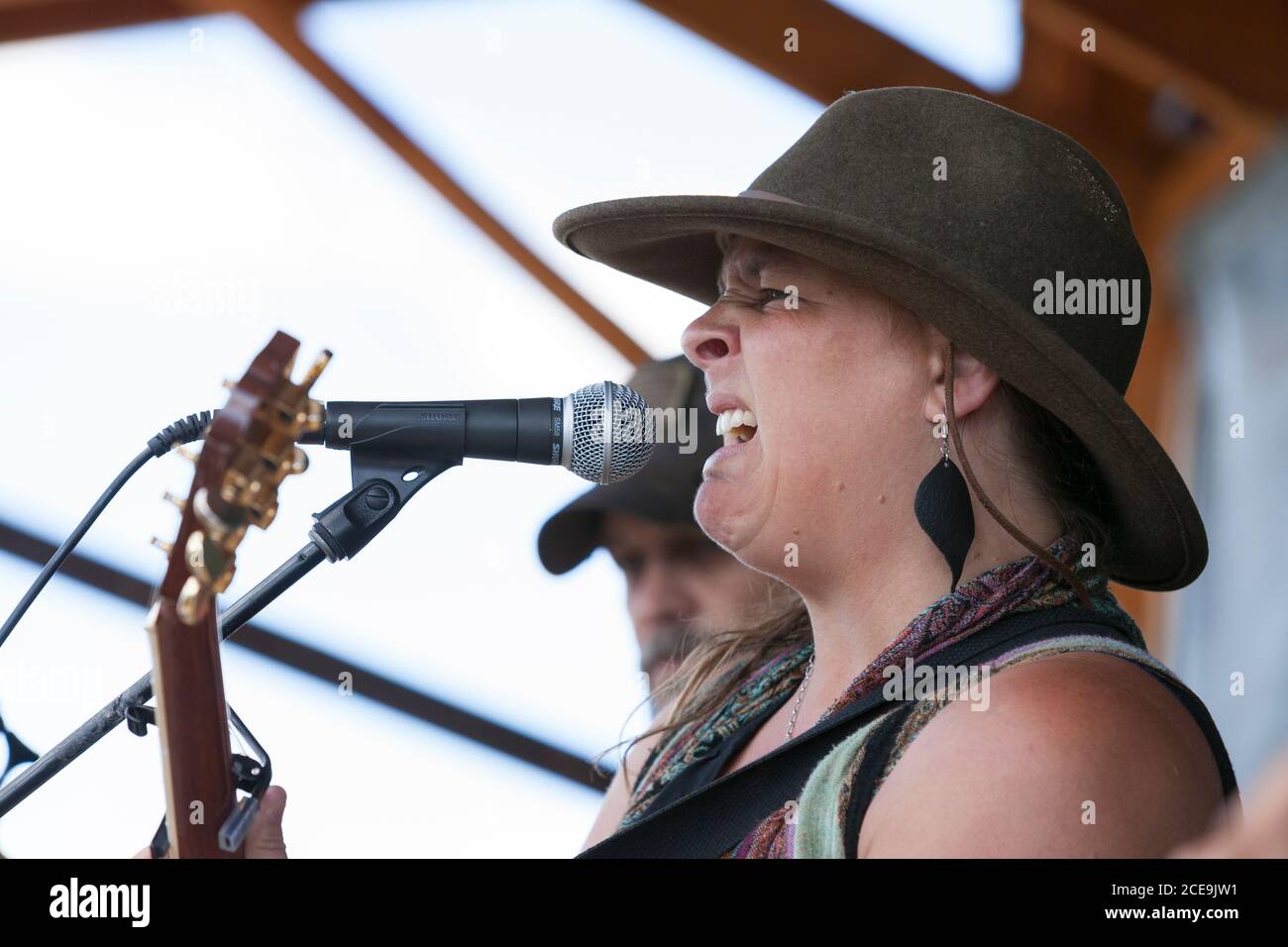 Sally Newsome-Ladd, accompanied by John Cotton on guitar, leads the Sol Mountain Band at a fair in Winninghoff Park in Philipsburg, Montana on Sunday, Stock Photo
