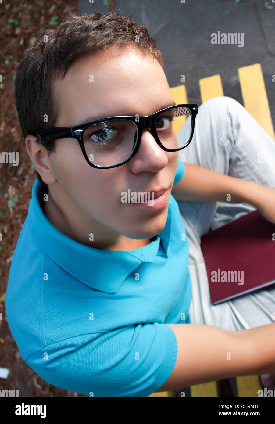wide angle portrait of young man in glasses Stock Photo