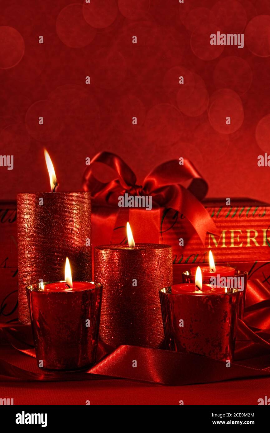 Christmas candles on a red vintage background Stock Photo