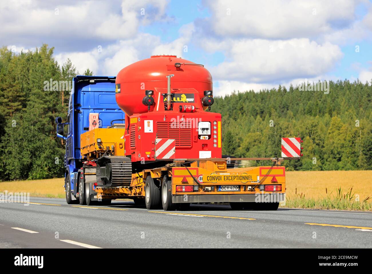 Blue Scania R500 semi trailer transports Allu PF Pressure Feeder as oversize load along highway 2 in autumn. Jokioinen, Finland. August 28, 2020. Stock Photo
