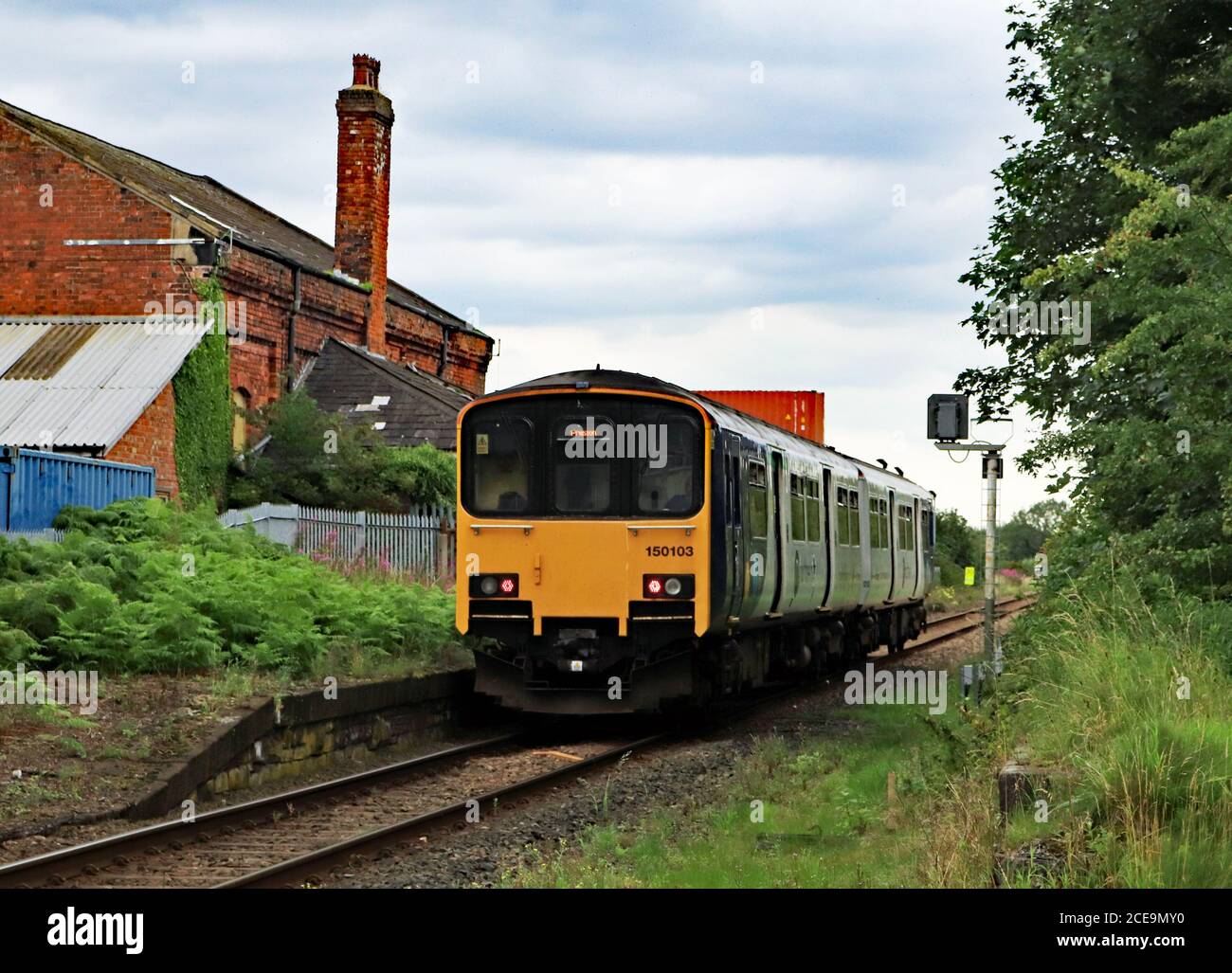A Northern train passes the closed station at Midge Hall, near Leyland in Lancashire where there is the possibility of the station reopening Stock Photo