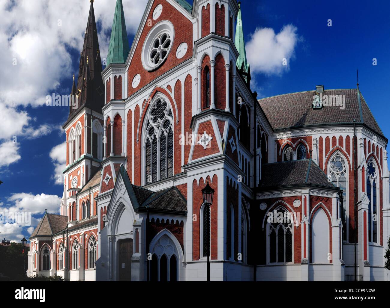 Red-White Colored Sofia Cathedral In Jonkoping On A Sunny Summer Day With Some Clouds In The Sky Stock Photo