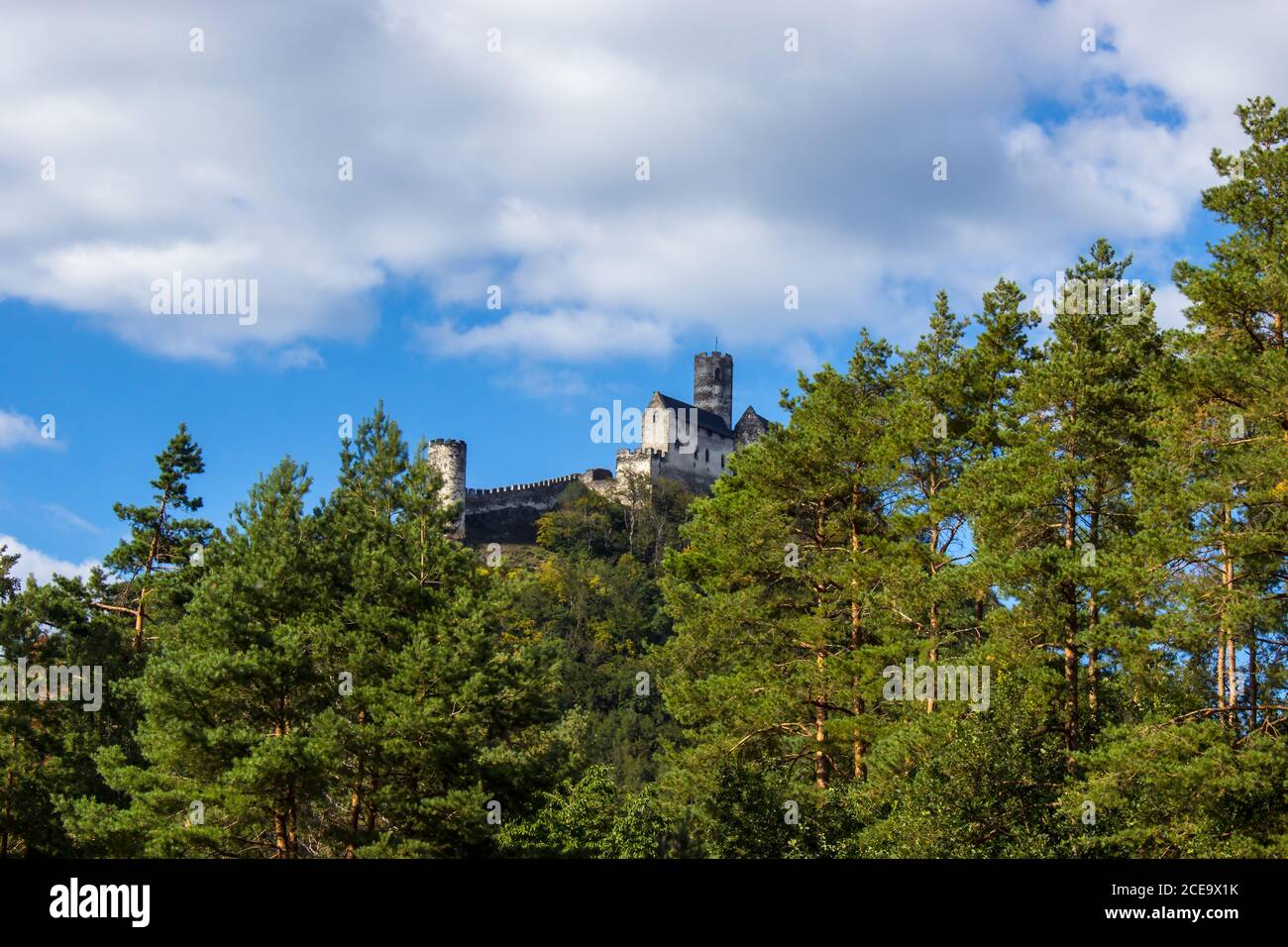 Panoramic view of Bezdez castle in the Czech Republic. In the foreground there are trees, in the background is a hill with castle Stock Photo