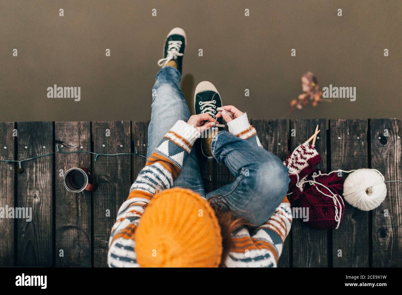Woman tying laces at water Stock Photo