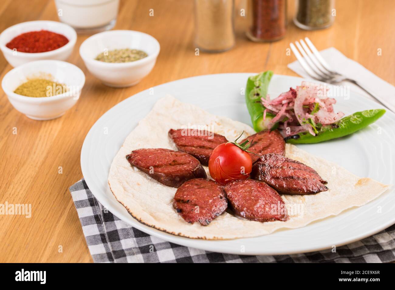 Sliced Turkish sausage on white plate cooked on the grill Stock Photo