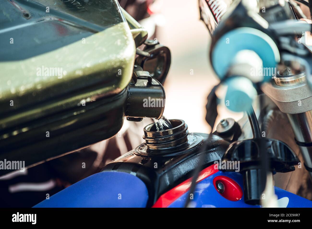 filling motorcycle with fuel before race Stock Photo Alamy