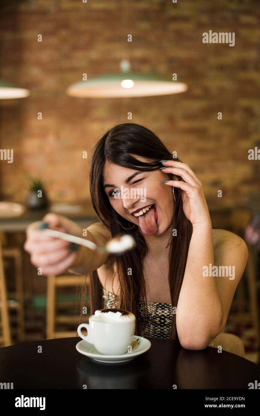 Young lady in cafe making grimace Stock Photo