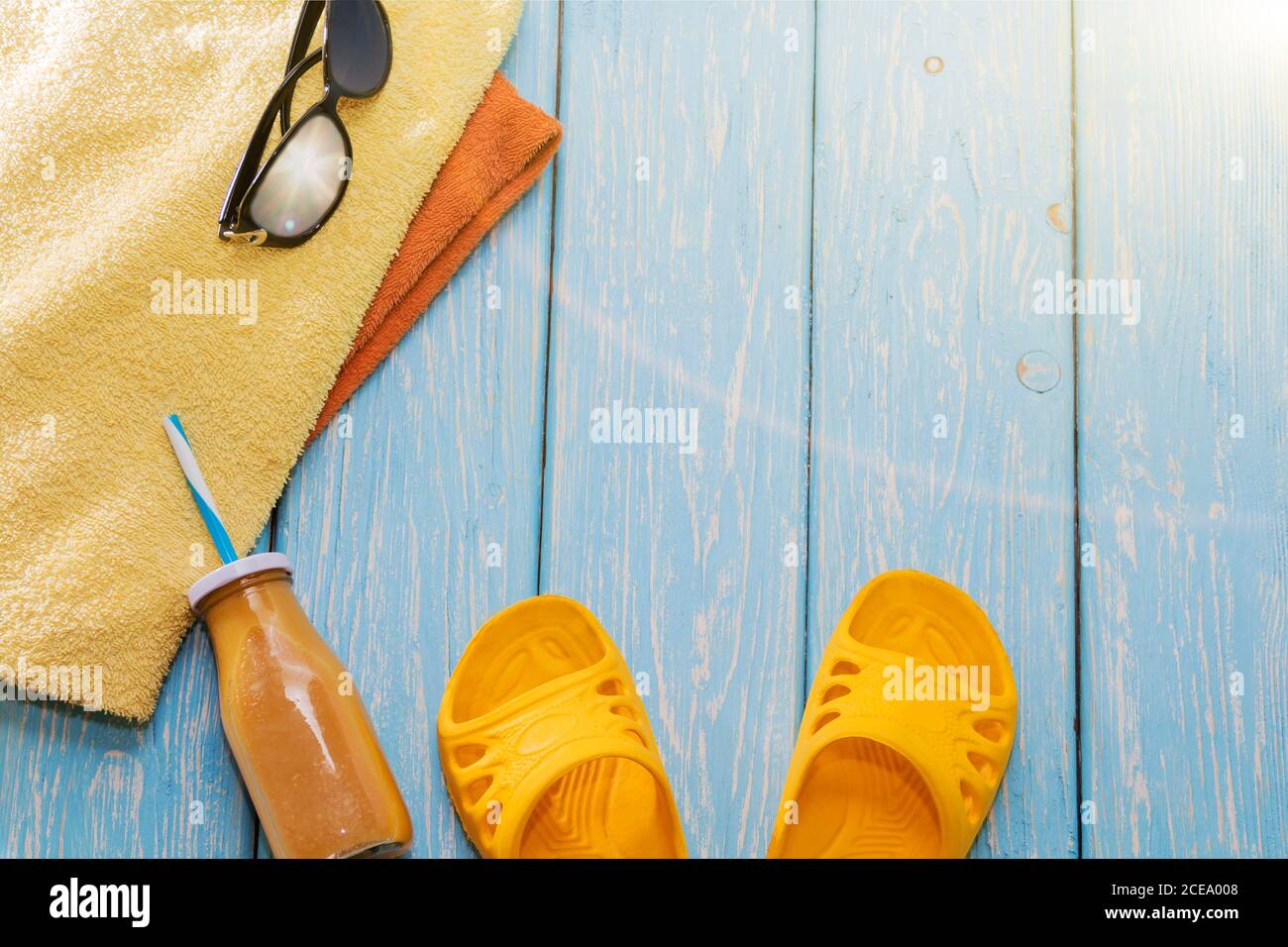 summer vacation on the beach. Yellow slippers, sunglasses and a cocktail. Stock Photo