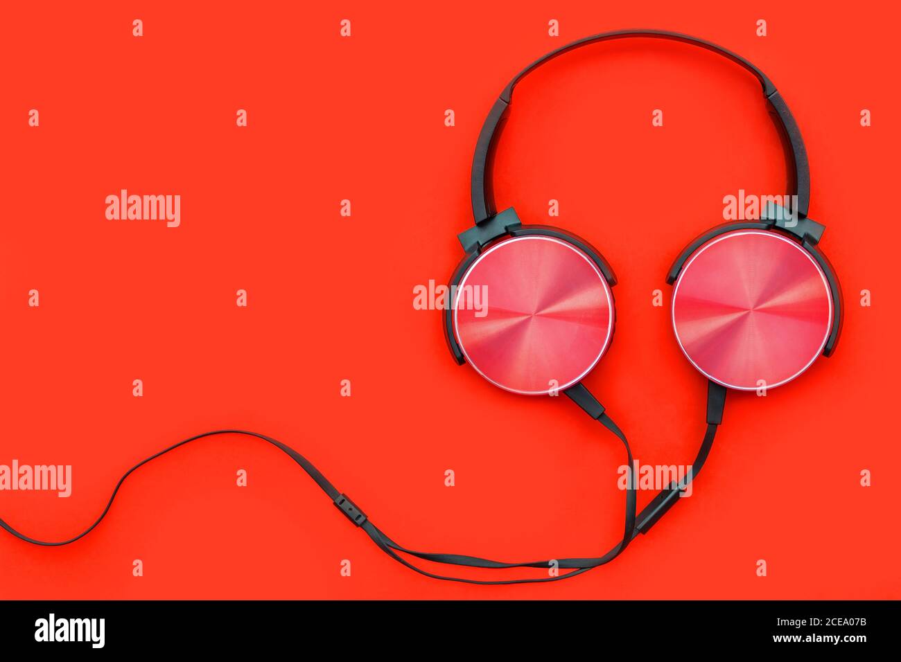 Modern red headphone on red background. Music concept. Stock Photo
