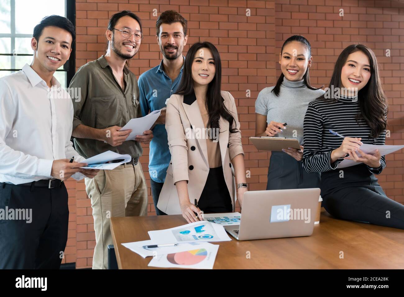 Portrait of a smiling group of diverse interracial corporate colleagues in meeting room for startup new business. Business coporate brainstorming conc Stock Photo