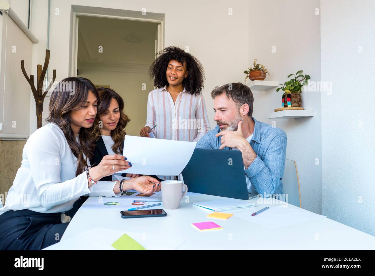Colleagues communicating during work Stock Photo