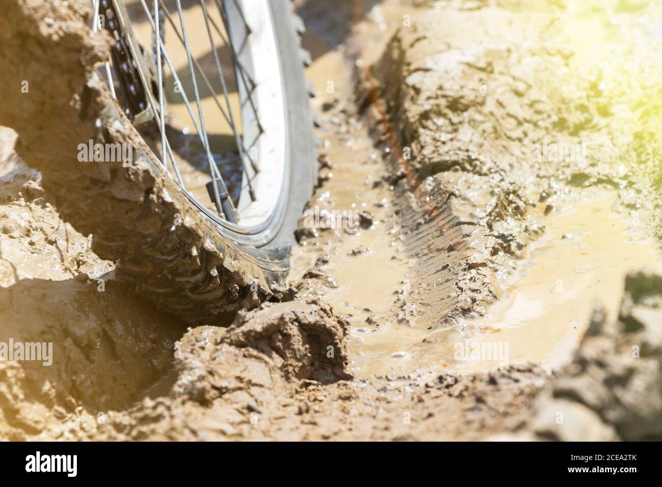 the Bicycle wheel is stuck in the mud. Close up Stock Photo Alamy