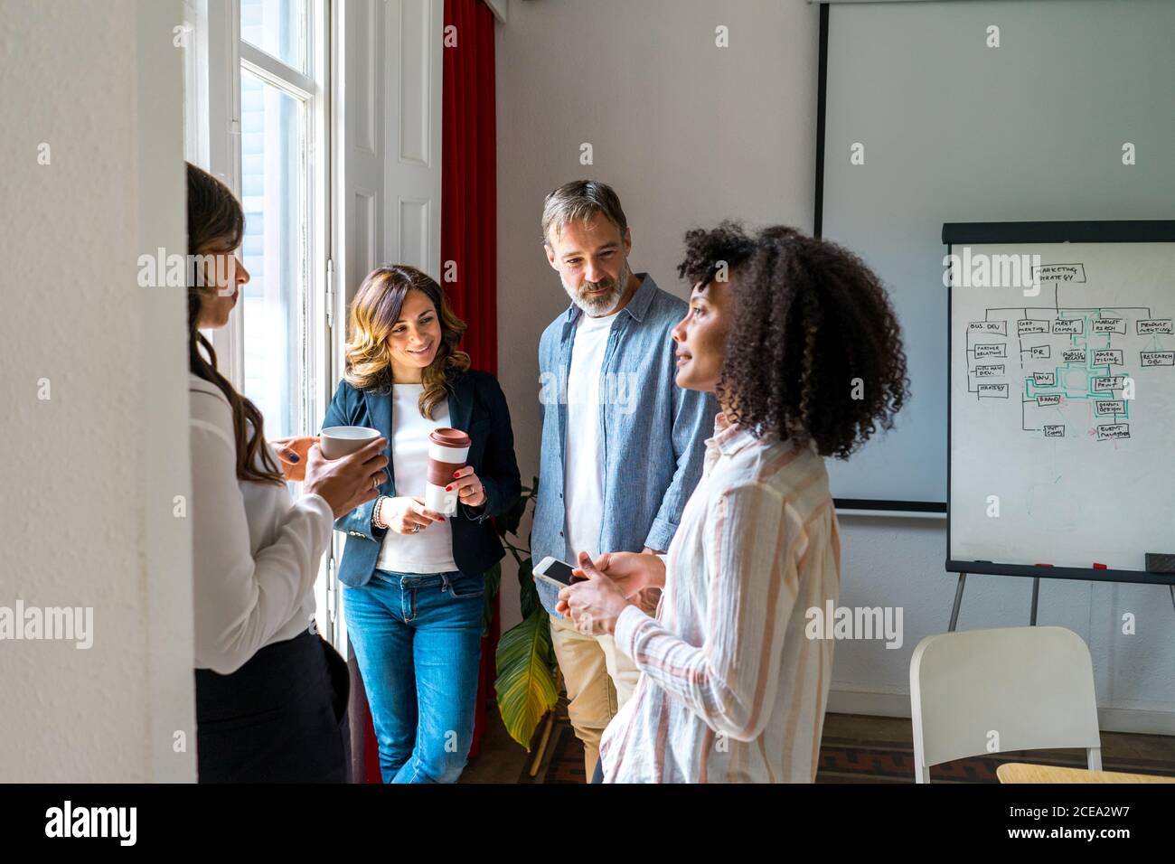 Colleagues talking near window Stock Photo