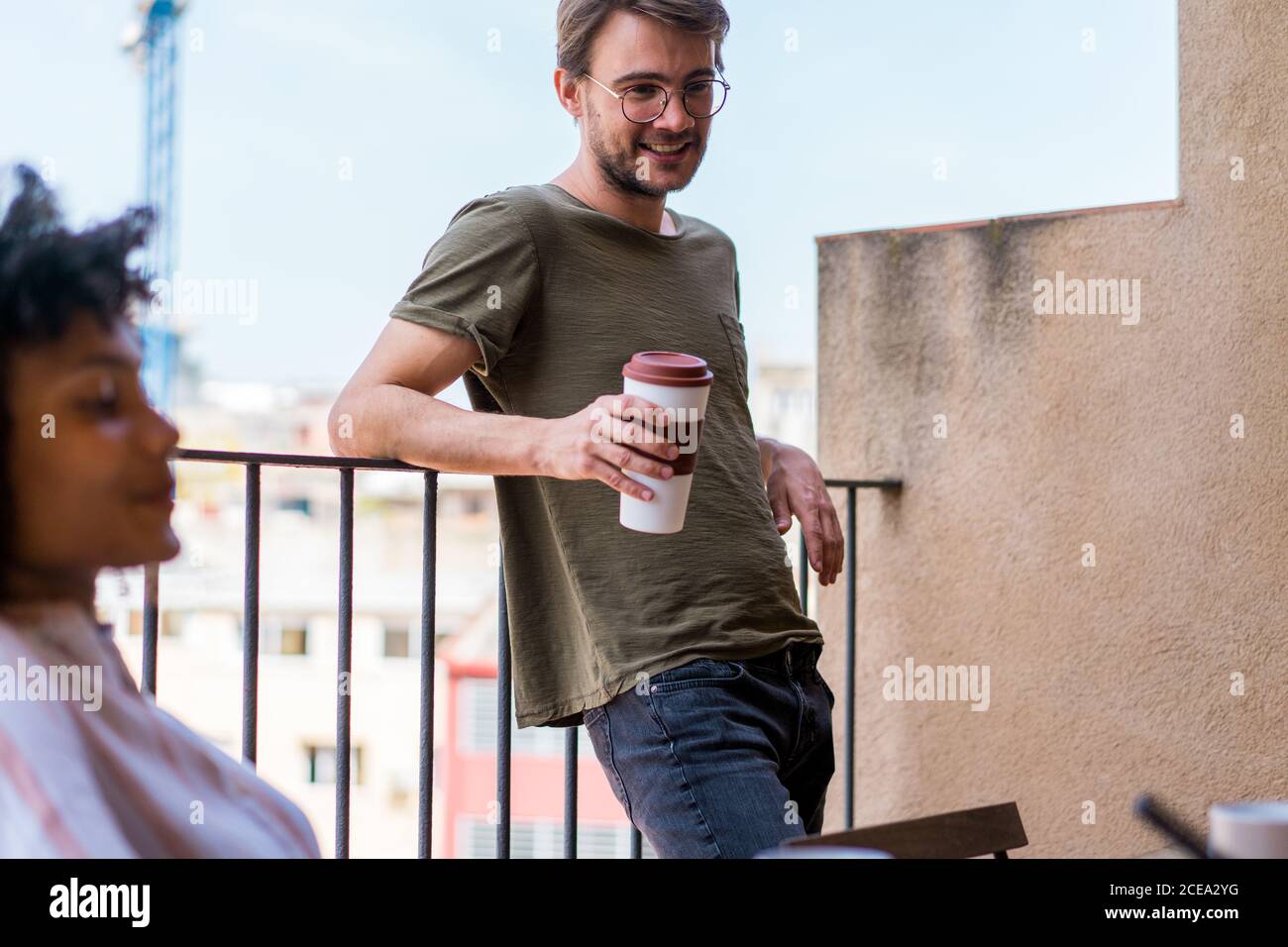 man leaning on fence Stock Photo