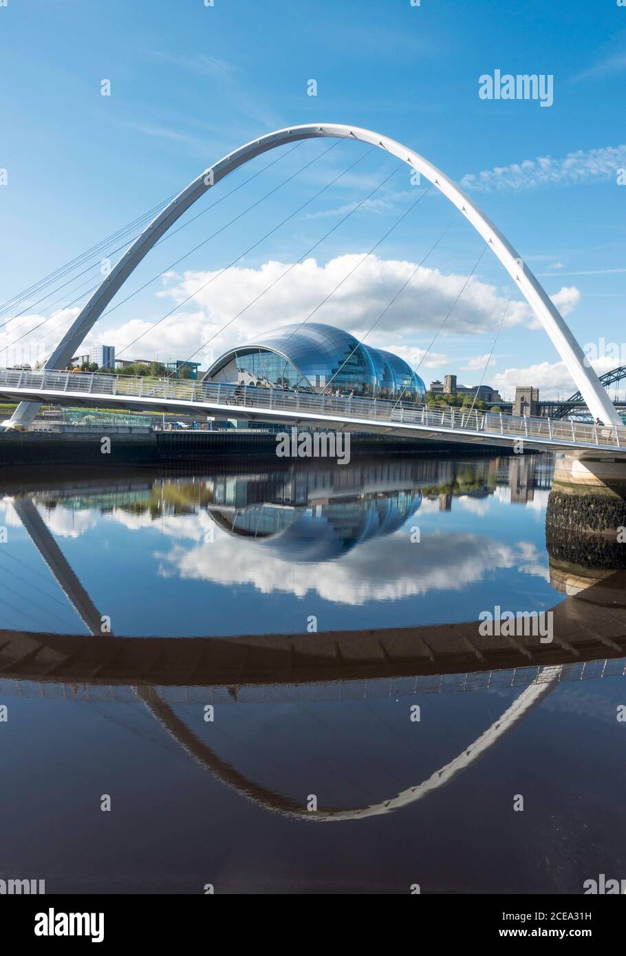 The Millennium bridge and Sage concert hall reflected in the river Tyne, Newcastle and Gateshead, north east England, UK Stock Photo