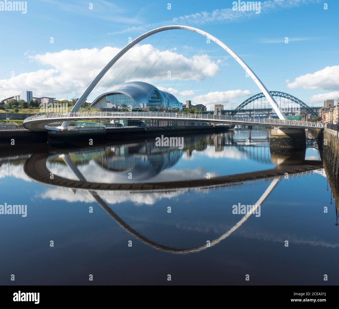 The Millennium bridge and Sage concert hall reflected in the river Tyne, Newcastle and Gateshead, north east England, UK Stock Photo