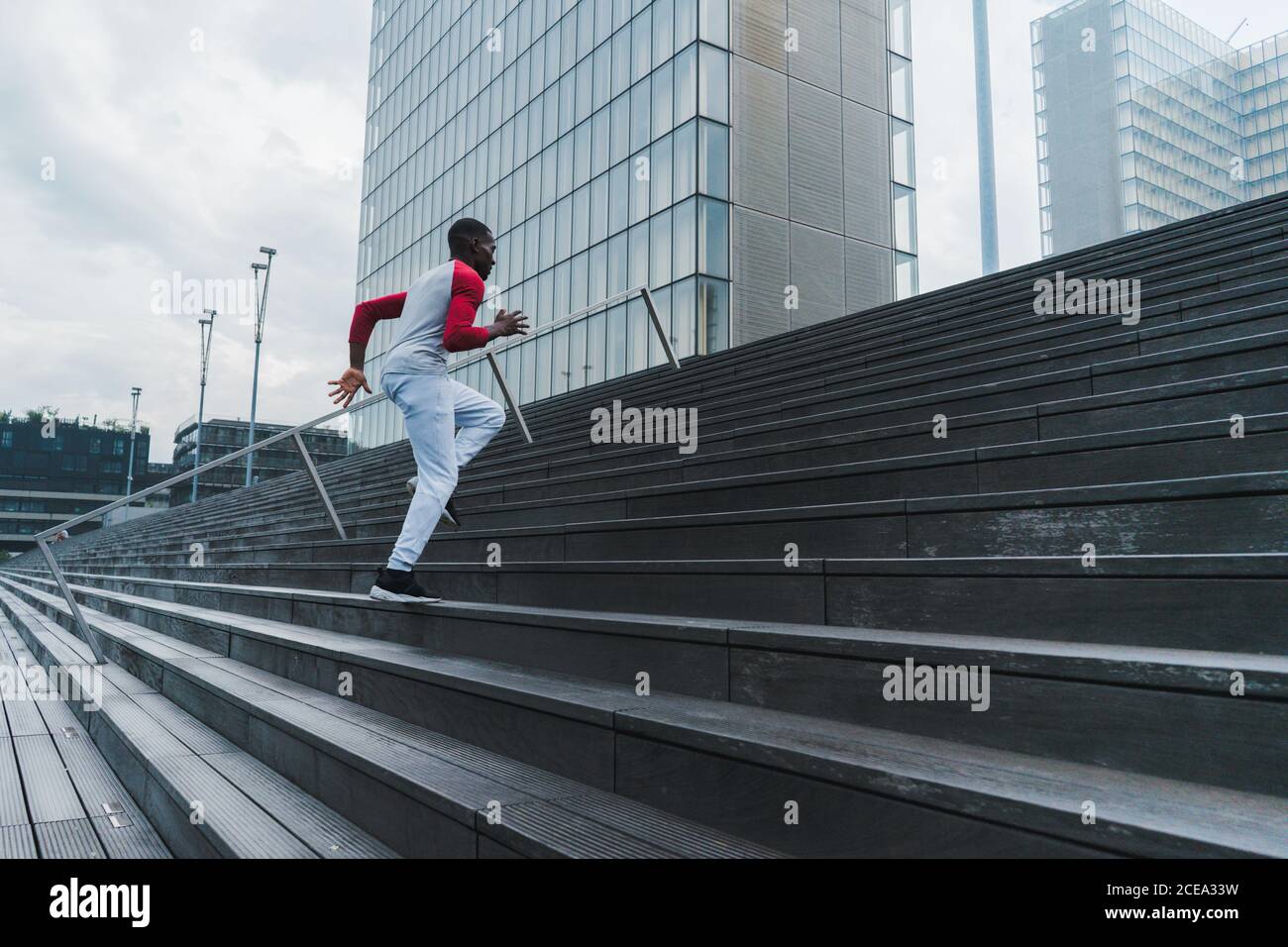 Black man running up stairs hi-res stock photography and images - Alamy
