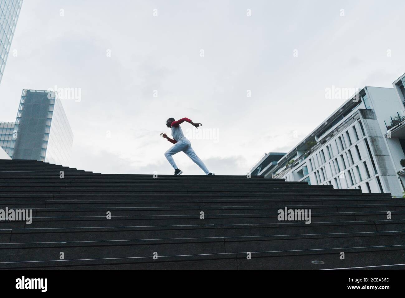 Black man running up stairs hi-res stock photography and images - Alamy