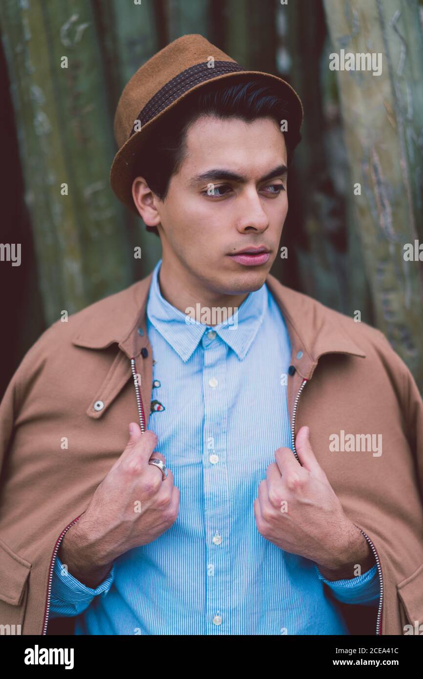 Thoughtful young handsome man at cactus Stock Photo