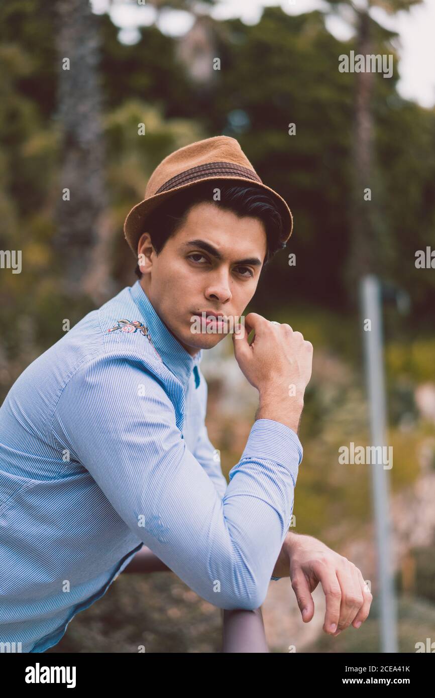 Thoughtful man leaning on handrail Stock Photo