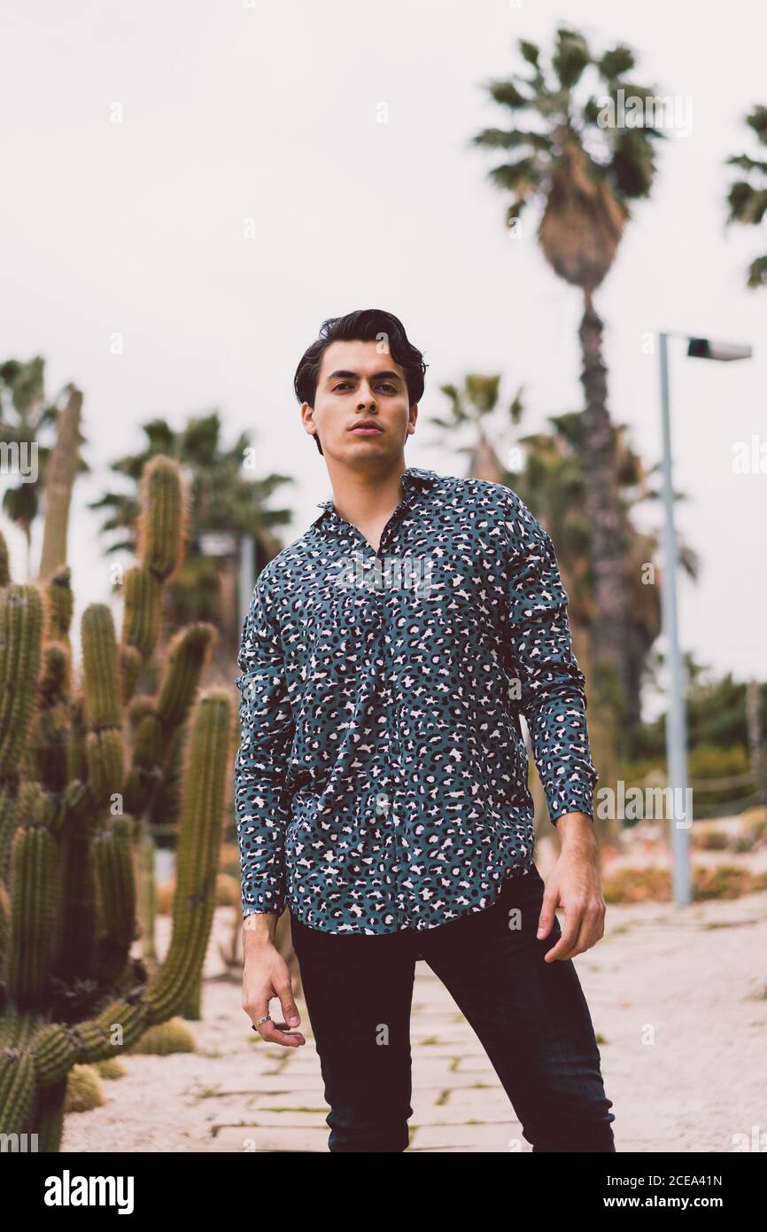 Young man posing at cactus Stock Photo