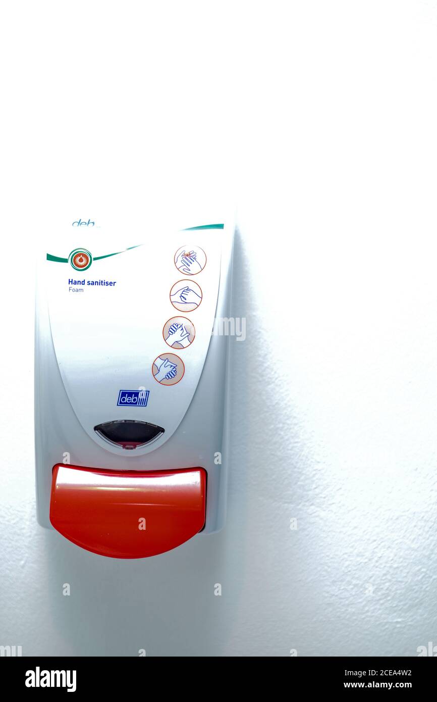 Hands under the automatic alcohol dispenser. Infection and hospitably concept. save and protect disease virus against germs and clean in the public Stock Photo