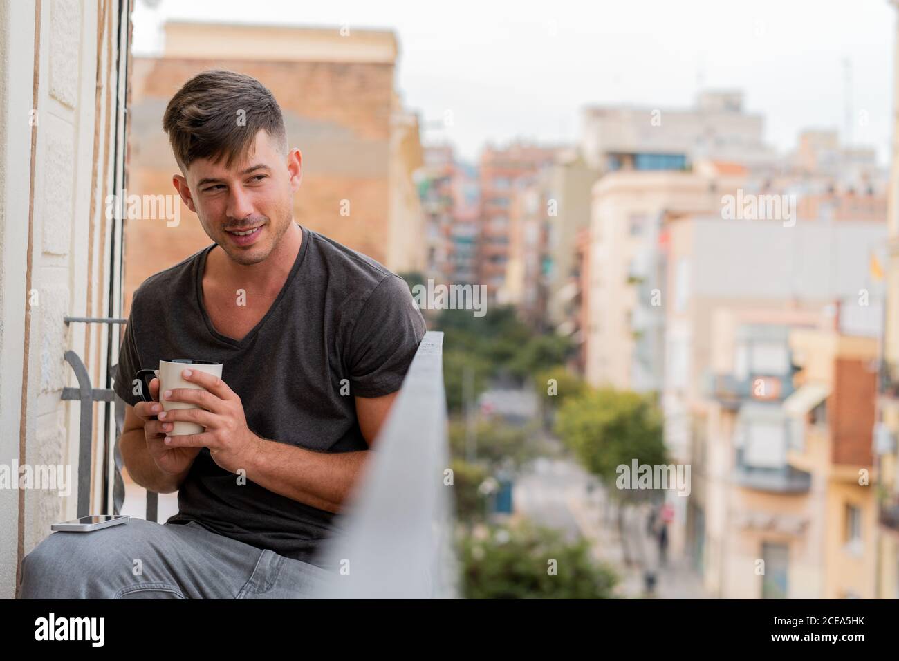 Relaxing man having coffee on balcony Stock Photo