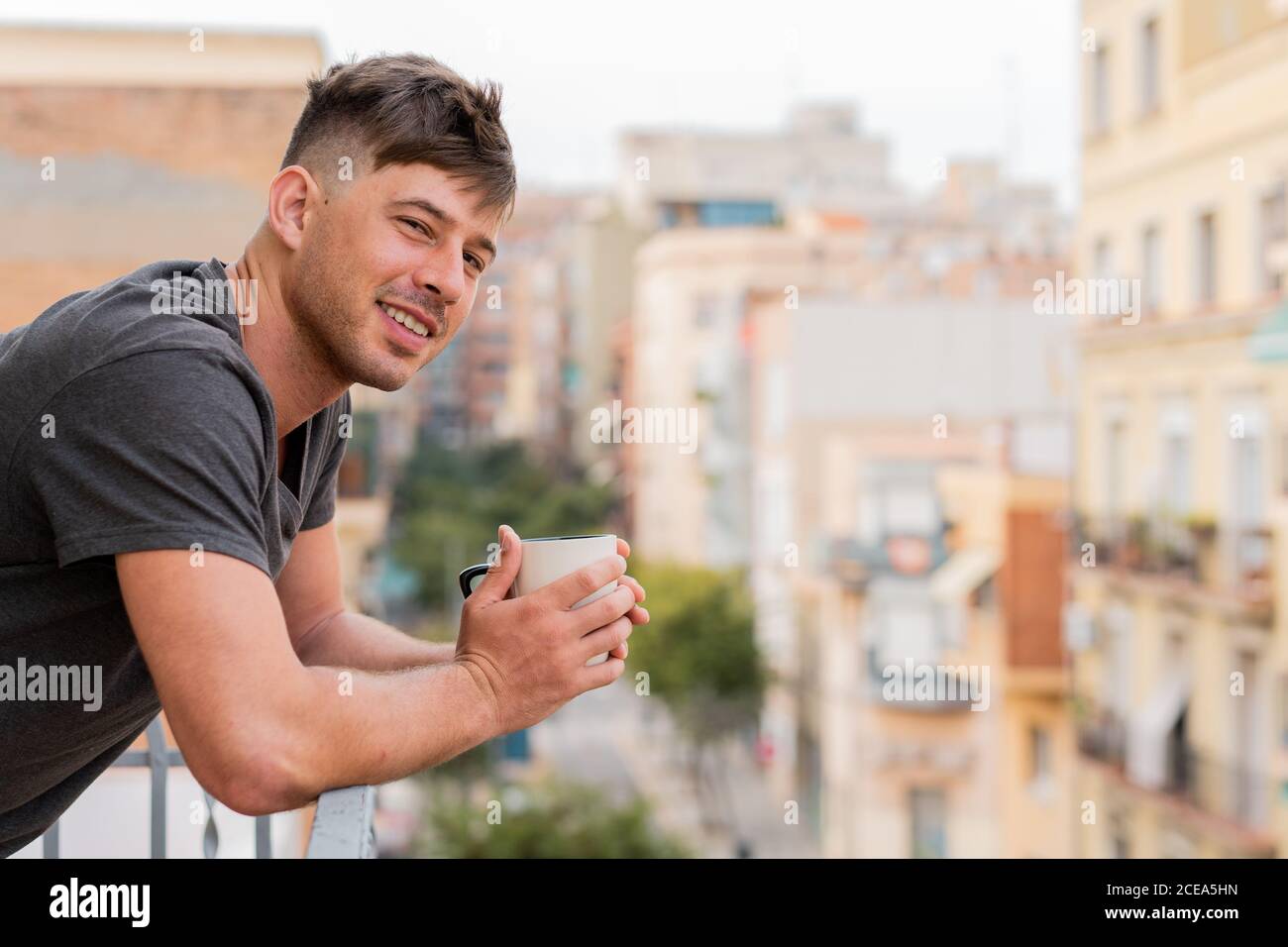 Relaxing man having coffee on balcony Stock Photo
