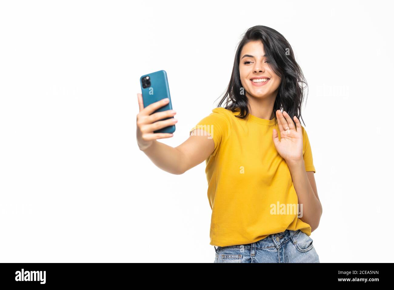 Sociable beautiful woman taking selfie or speaking on video call using cell  phone over white background Stock Photo - Alamy