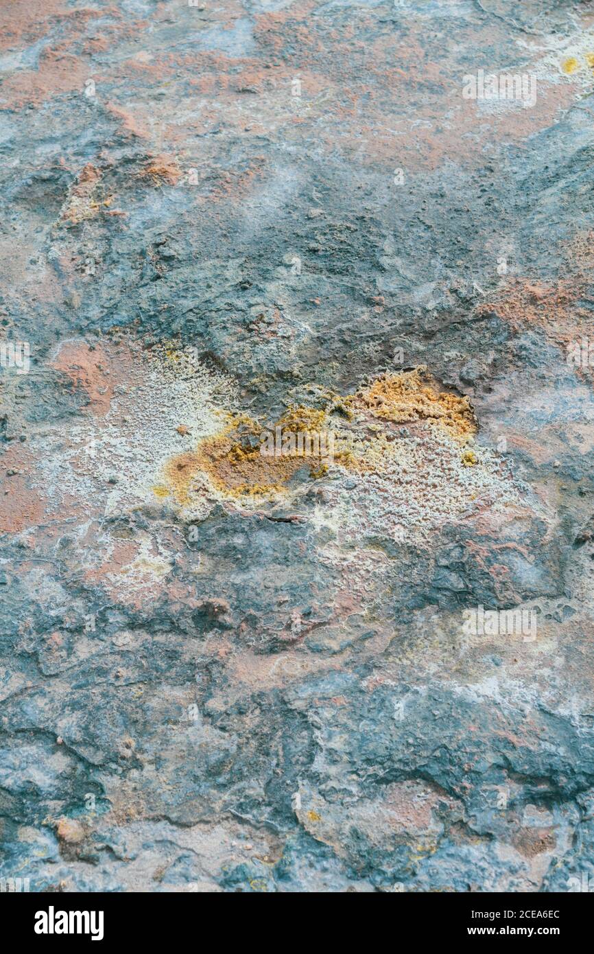 Lichen growing on rhyolite structure with silica and sulfur deposits in active volcanic zone of Namaskardh in Iceland from above Stock Photo