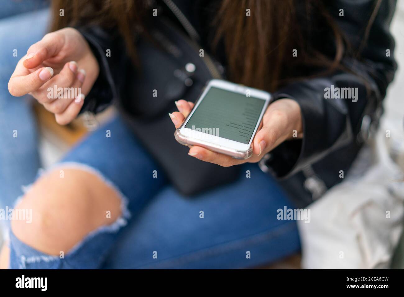 Lady using smartphone near Woman Stock Photo