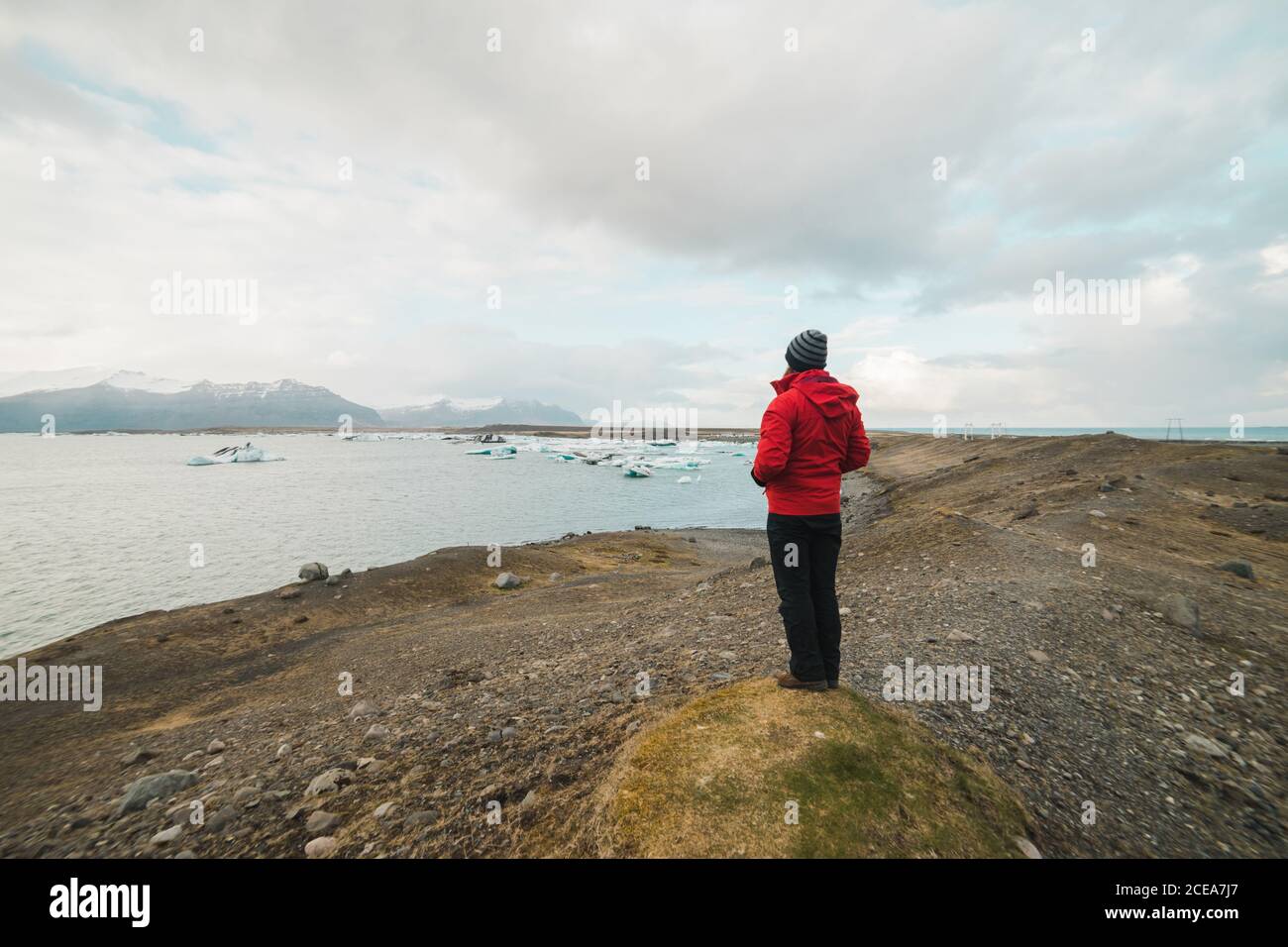 man standing by lake looking away Stock Photo