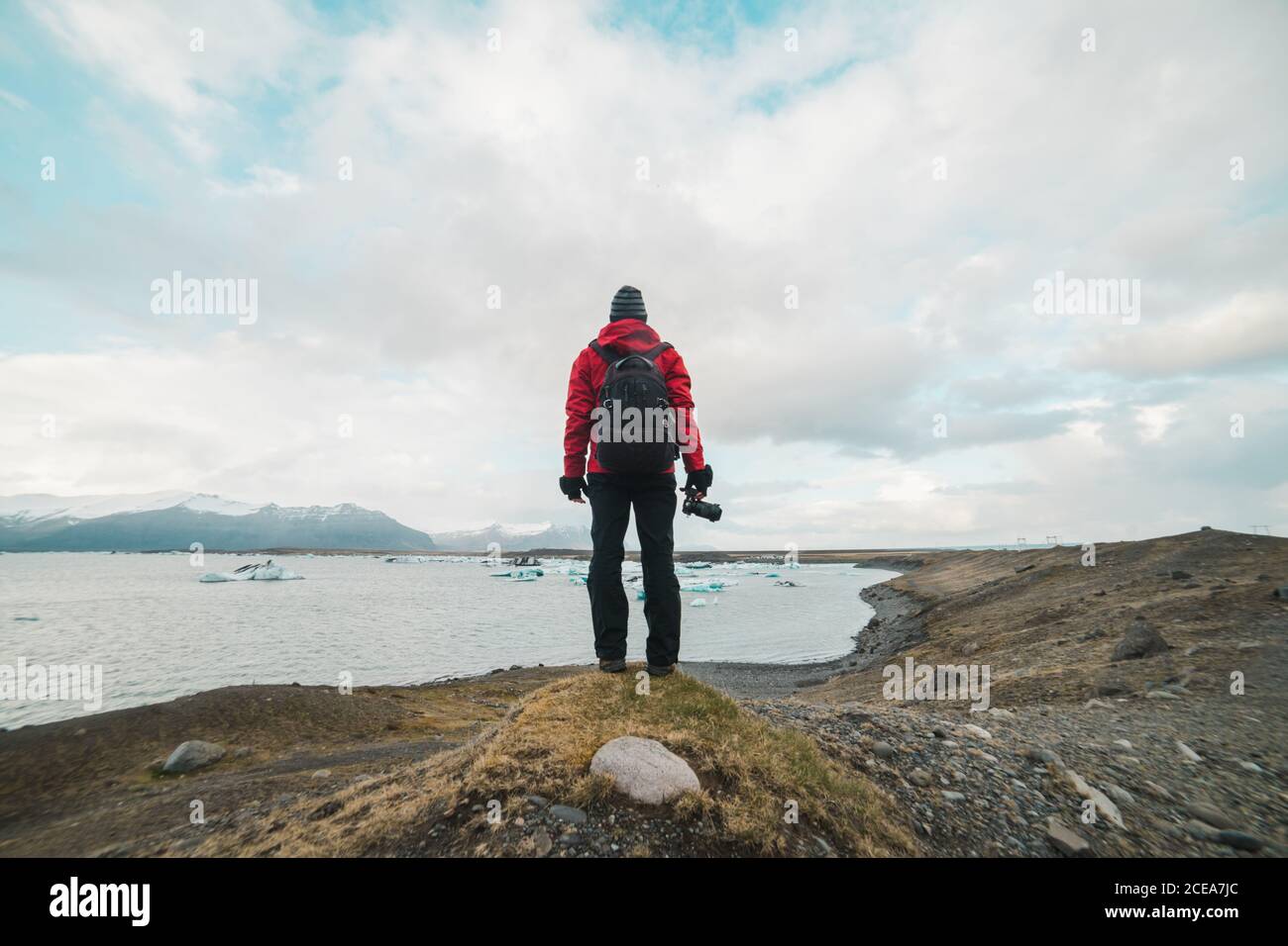 man standing by lake looking away Stock Photo