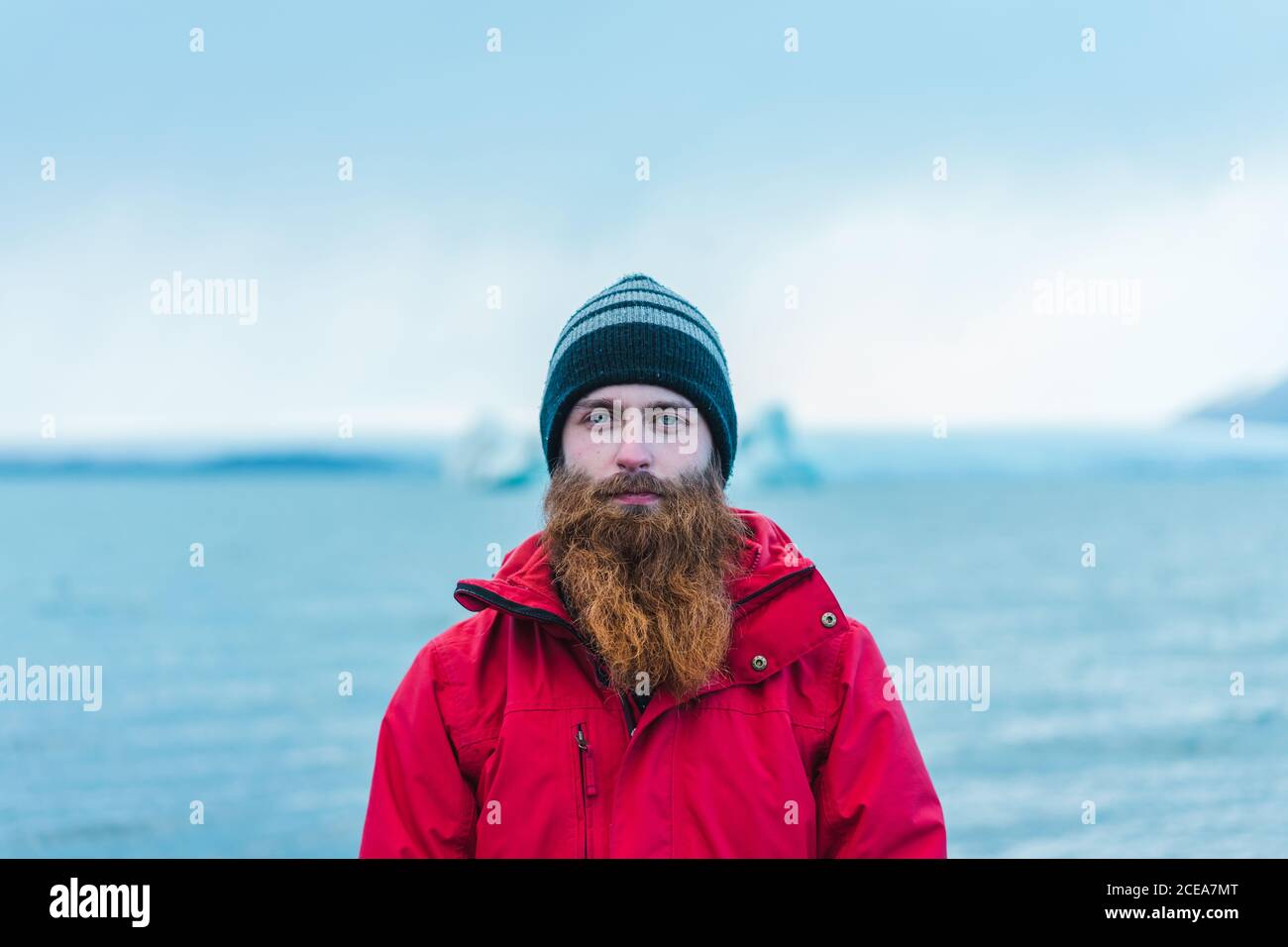 Attractive bearded man in warm clothes by water Stock Photo